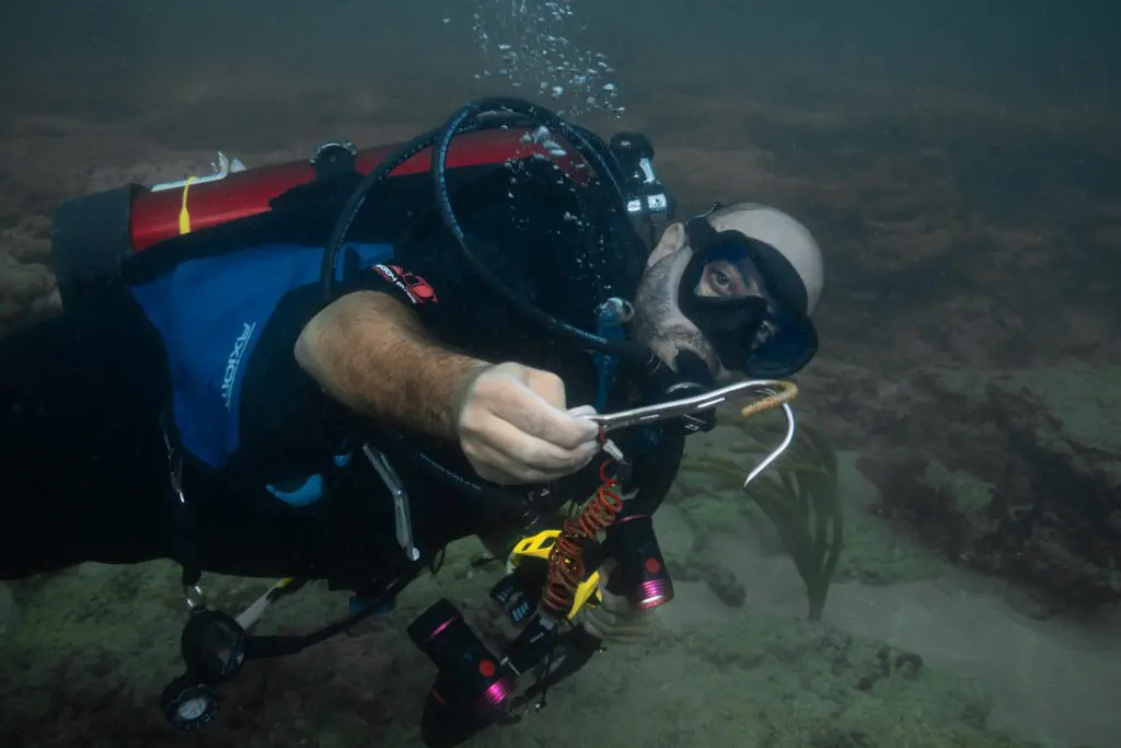 Co founder Andre Saade picking up jetsam on a dive