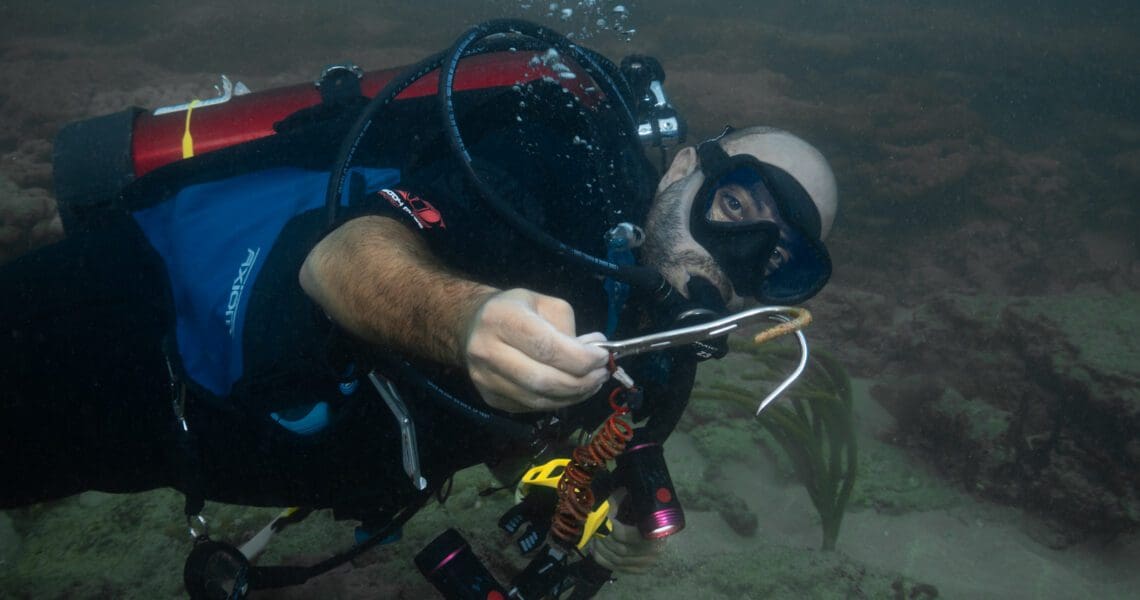 Co founder Andre Saade picking up jetsam on a dive