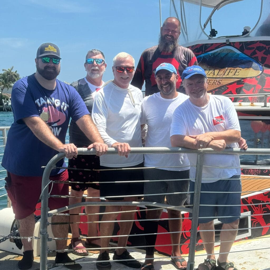 Cody, Mark, Jim, Andre and Christopher with AquaLife co-owner and instrutor member Skip in back onboard the Shark Bait