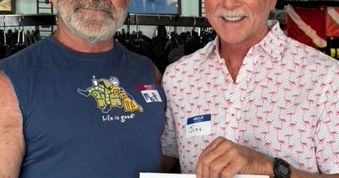 Door prize winner Jim LaBrie presented his winning ticket by last quarter's winner Matt Constantine.