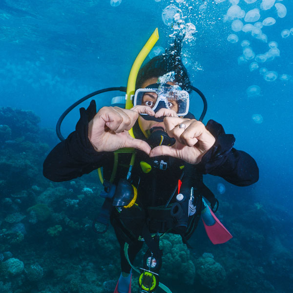 Scuba diver giving the Love hand signal